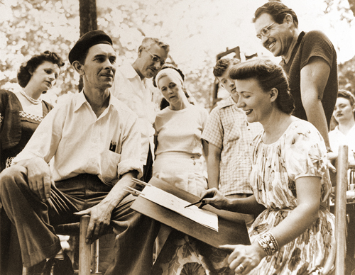 Elsie painting in Basin Park while Louis observes